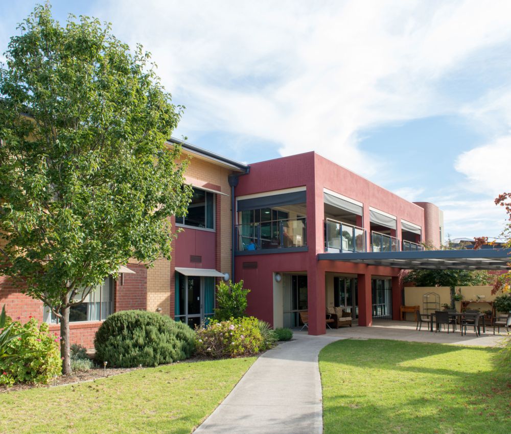 Front garden area at Eldercare Seaford complete with garden path and undercover area.