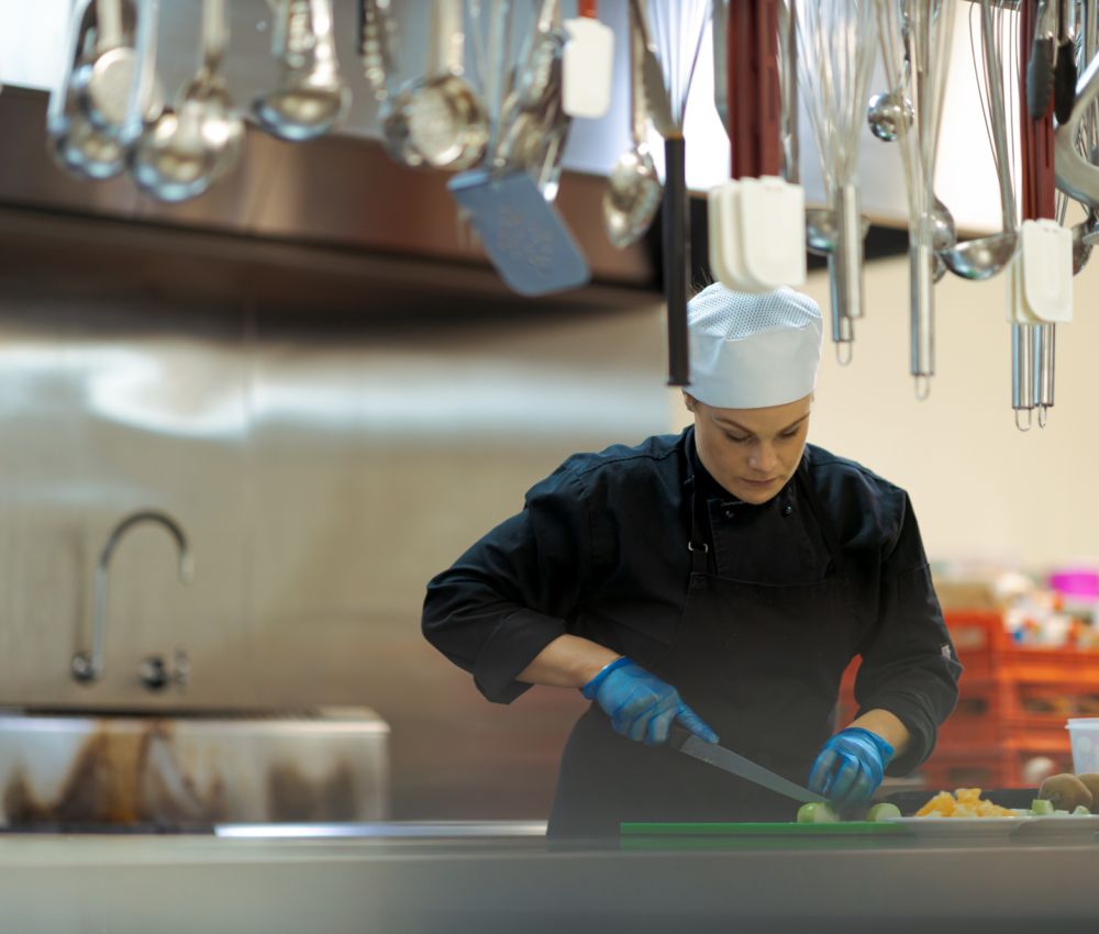 An Eldercare chef prepares vegetables in the industrial kitchen at Allambi.