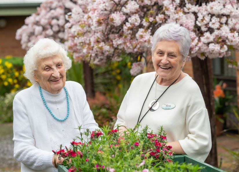 Eldercare Sash Ferguson resident and a volunteer smiling at camera.