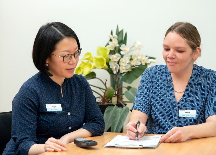 Skye, Trainee Care Assistant at Eldercare taking notes.
