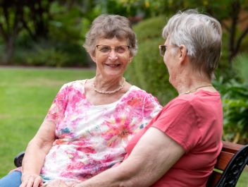 Eldercare The Village Retirement Living residents looking at each other.