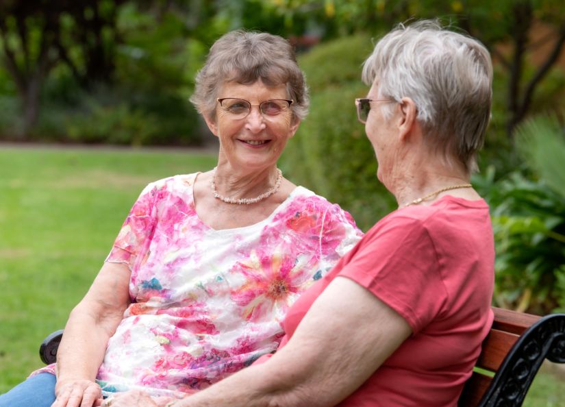 Eldercare The Village Retirement Living residents looking at each other.