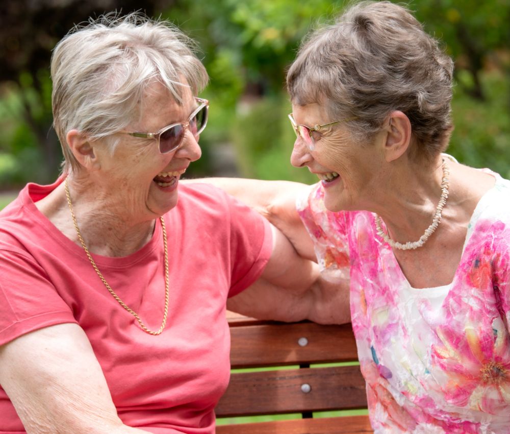 Eldercare Collett Barker Retirement Living residents smiling at each other.