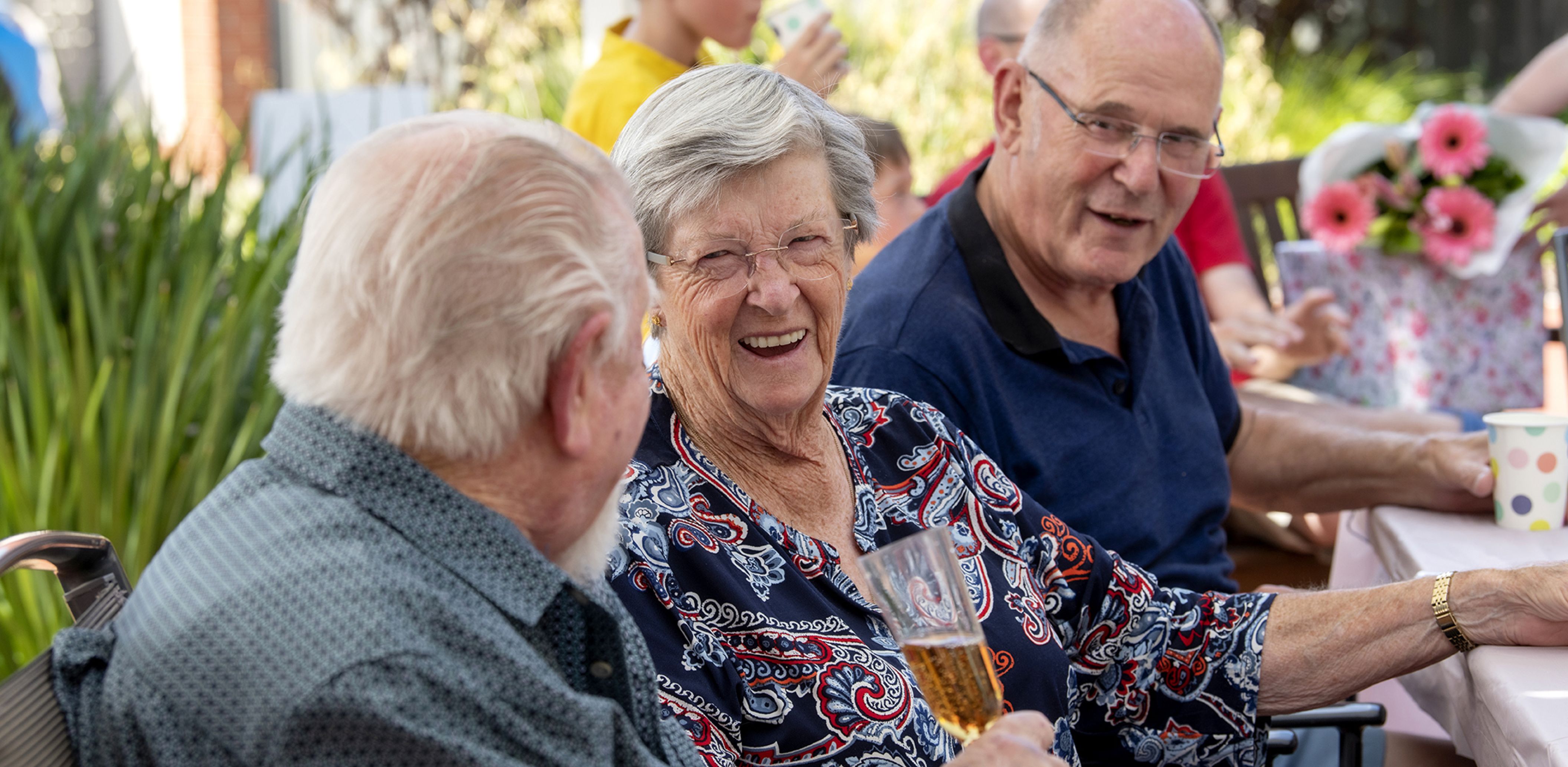 Eldercare Mulberry Grove Retirement Living residents talking and smiling at each other.