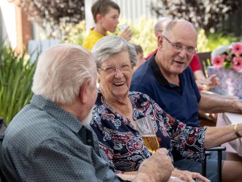 Eldercare Mulberry Grove Retirement Living residents talking and smiling at each other.
